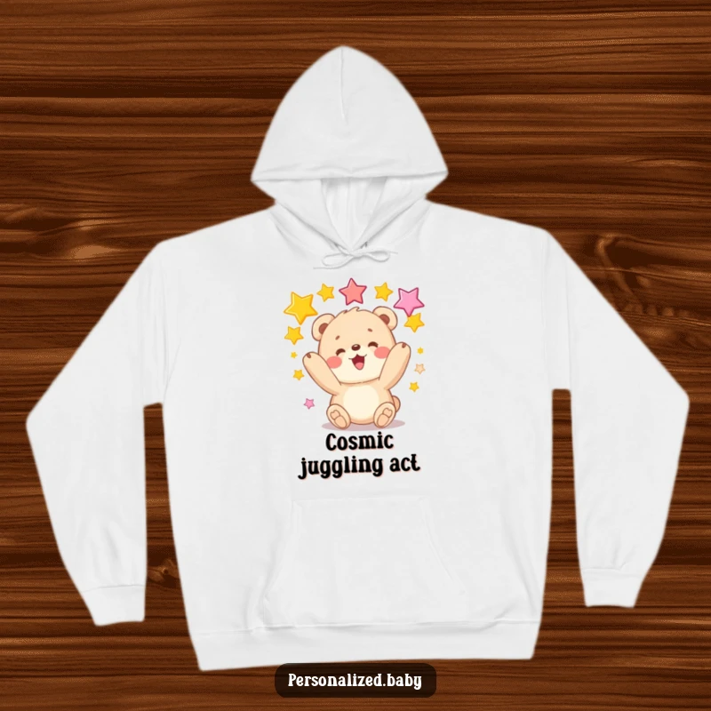 Funny hoodie with a fluffy bear cub juggling colorful stars, a cozy and humorous garment for delightful comfort.