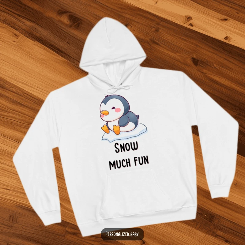 Funny chubby baby penguin hoodie, happily sliding down a snowy hill on its belly, cozy and warm.