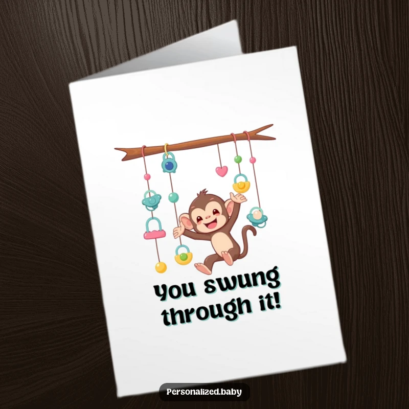 Funny Free Printable Congratulations Card: A mischievous monkey tangled in a mobile of pacifiers, symbolizing the delightful chaos of babies.