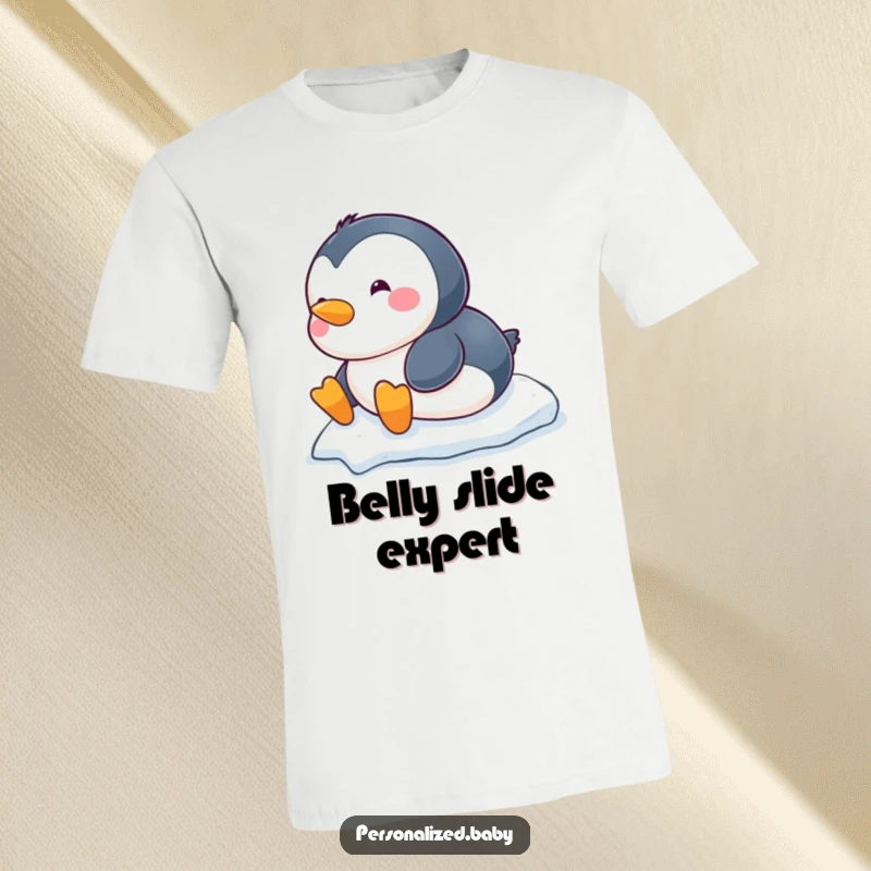 Funny chubby baby penguin t-shirt, sliding down a snowy hill on its belly, a hilarious depiction of arctic play.