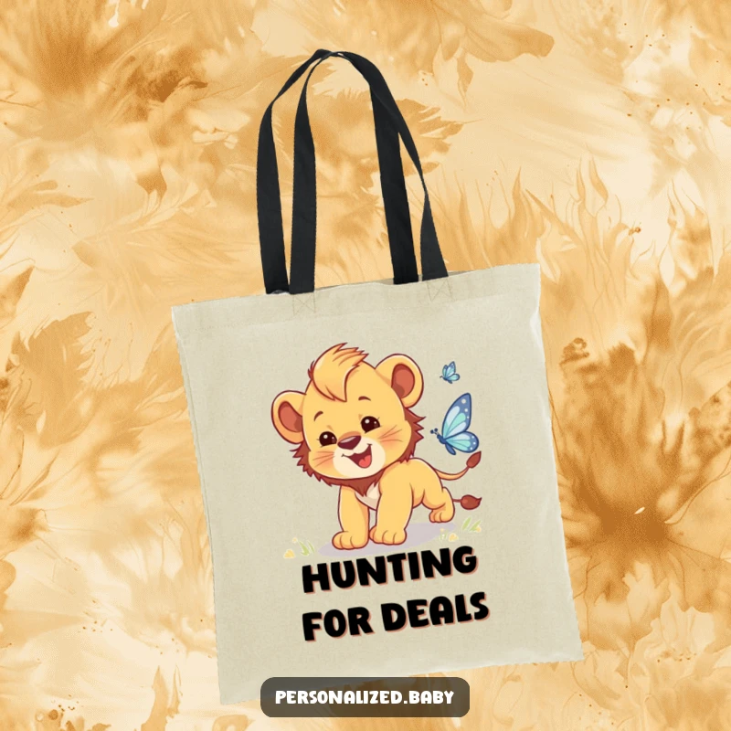 Funny tote bag showcasing a clumsy baby lion cub with wide eyes chasing a delicate, sparkling butterfly.